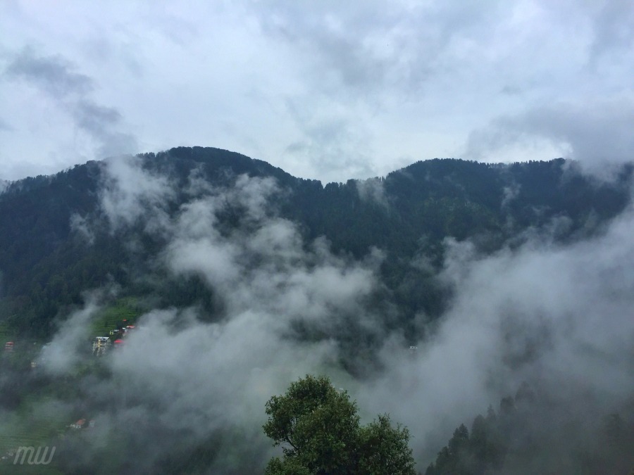 Mountain covered with clouds, view from the balcony of our hostel.