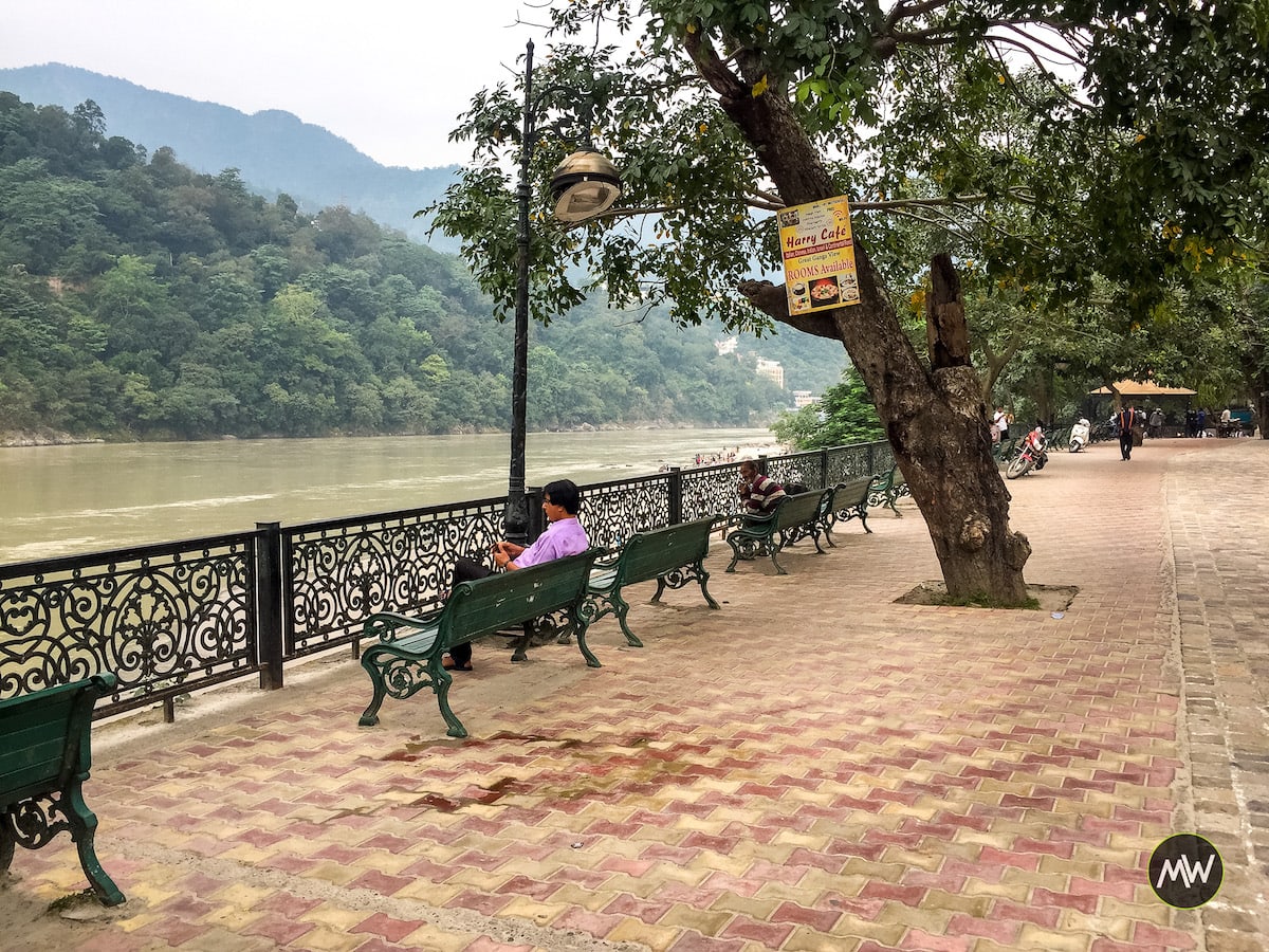 A man sitting on a bench at Marine Drive Rishikesh - Rishikesh Travel Guide